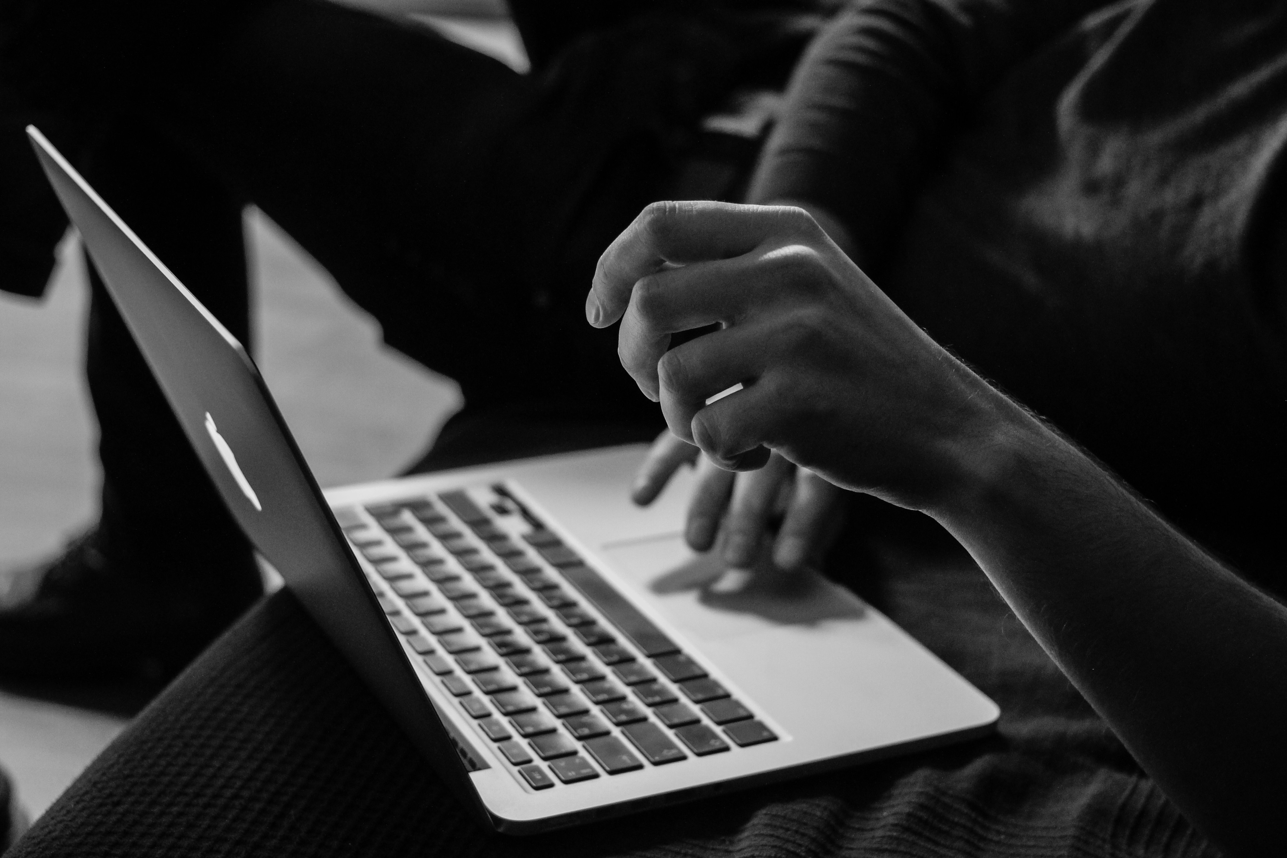 about section image of hands typing on a laptop